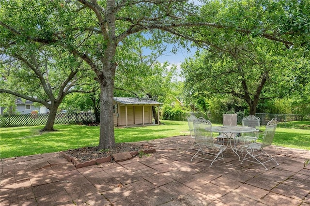 1210 Munson Ave, College Station, TX 77840 - view of patio / terrace featuring outdoor dining space and an outbuilding