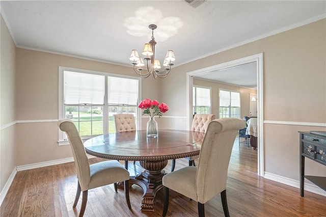 1210 Munson Ave, College Station, TX 77840 - dining space with a chandelier, baseboards, crown molding, and wood finished floors