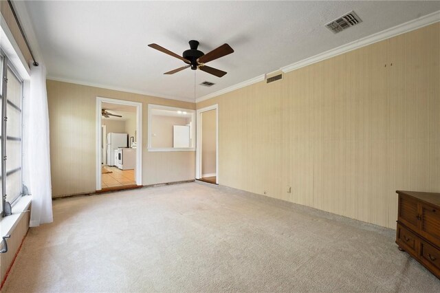 1210 Munson Ave, College Station, TX 77840 - unfurnished bedroom with light colored carpet, freestanding refrigerator, ornamental molding, and a ceiling fan