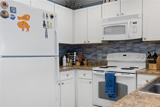 kitchen featuring white cabinetry, white appliances, and tasteful backsplash