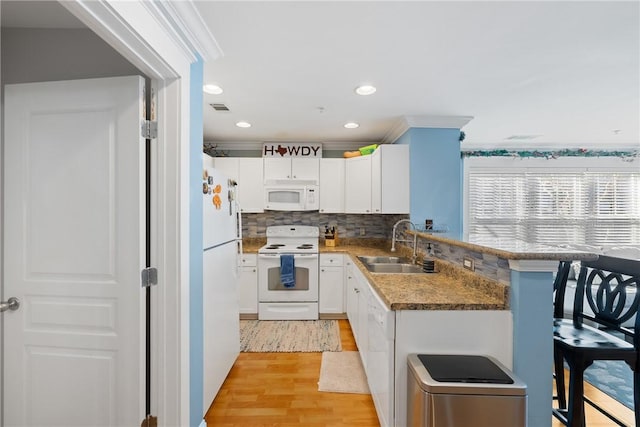 kitchen with white cabinetry, sink, decorative backsplash, ornamental molding, and white appliances