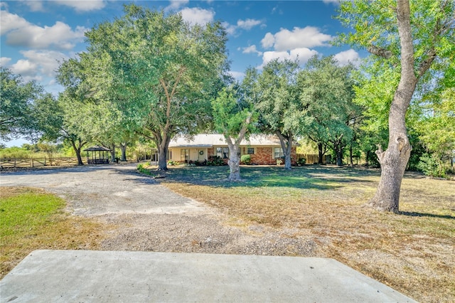 view of front of home with a gazebo and a front lawn