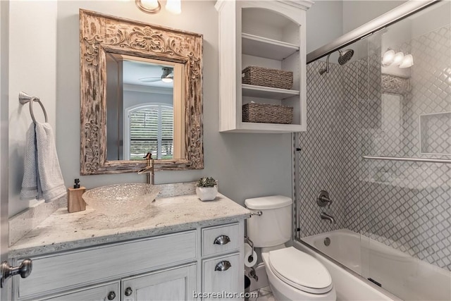 full bathroom with vanity, toilet, and enclosed tub / shower combo