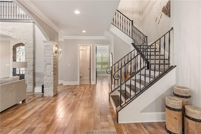 entrance foyer featuring hardwood / wood-style floors and ornamental molding