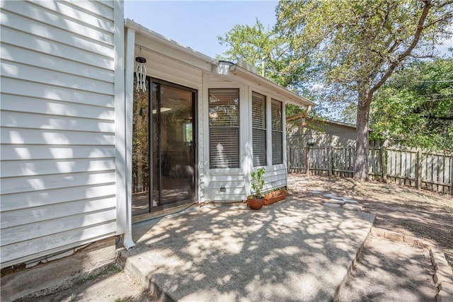 doorway to property with a patio area and fence