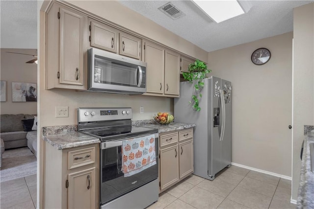 kitchen with light tile patterned floors, visible vents, appliances with stainless steel finishes, and a textured ceiling