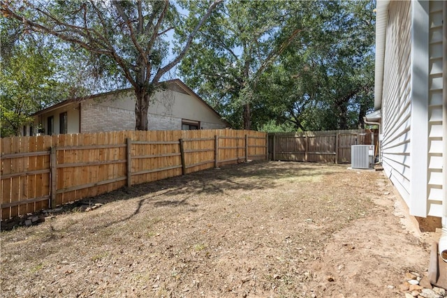 view of yard featuring central air condition unit and a fenced backyard