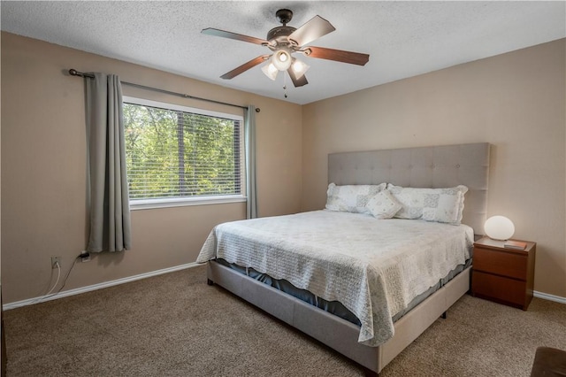 bedroom featuring carpet floors, a ceiling fan, baseboards, and a textured ceiling