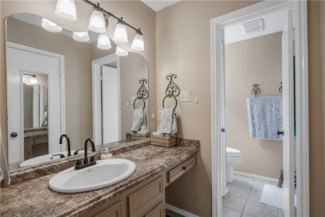 bathroom with visible vents, toilet, vanity, tile patterned flooring, and baseboards