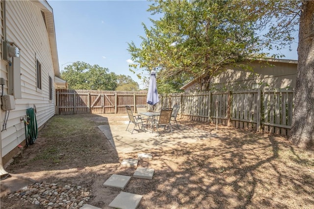 view of yard featuring a patio and a fenced backyard