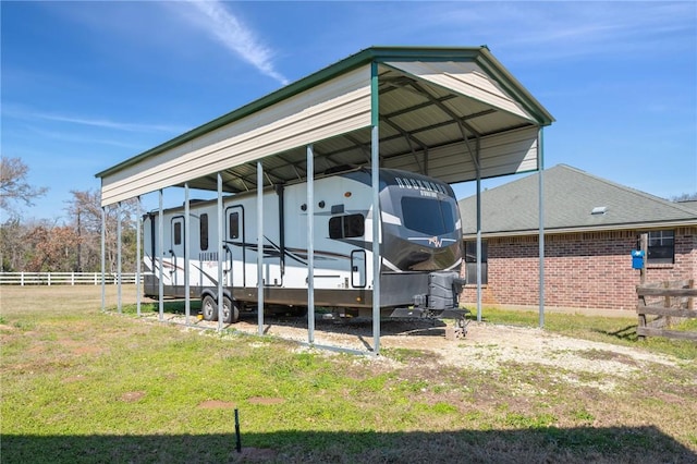 exterior space featuring fence and a carport