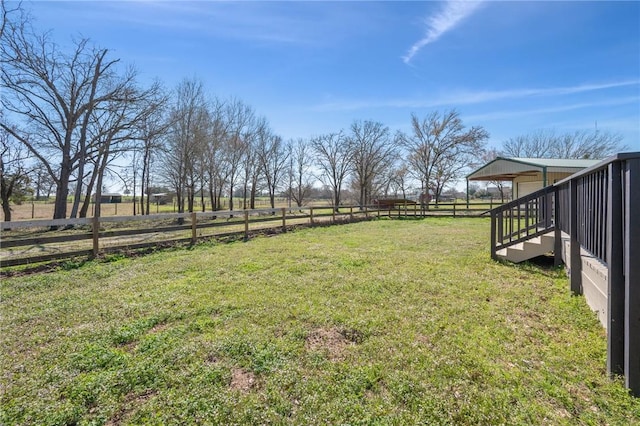 view of yard featuring a rural view and fence