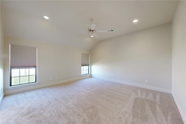empty room featuring baseboards, carpet, a ceiling fan, and visible vents