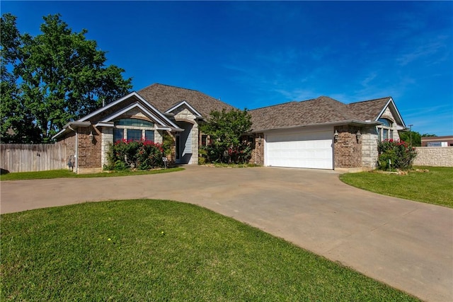 view of front of property featuring fence, driveway, brick siding, and a front yard