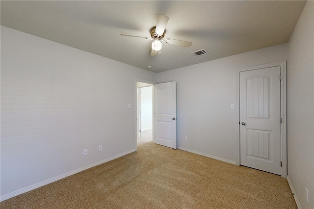 unfurnished bedroom with visible vents, baseboards, and light colored carpet