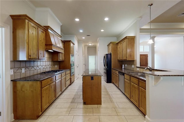 kitchen featuring appliances with stainless steel finishes, a sink, a center island, backsplash, and ornamental molding