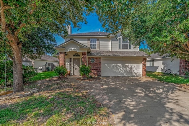 view of front of home featuring a garage and central air condition unit