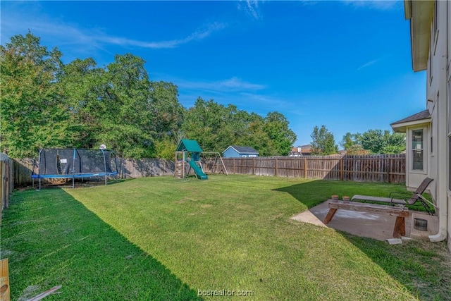 view of yard with a playground, a trampoline, and a patio area