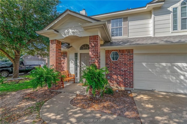 view of exterior entry with a garage