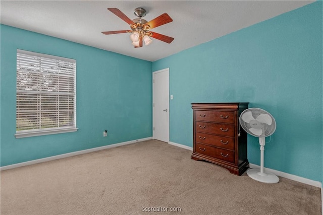 unfurnished bedroom with light colored carpet and ceiling fan