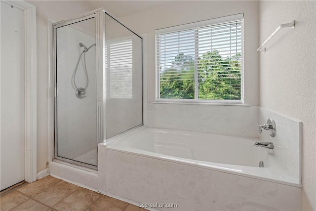 bathroom with tile patterned floors and independent shower and bath