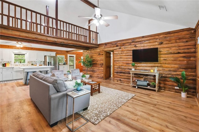 6508 Old Independence Rd, Brenham, TX 77833 - living area featuring ceiling fan, high vaulted ceiling, rustic walls, beam ceiling, and a fireplace