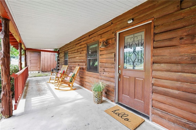 6508 Old Independence Rd, Brenham, TX 77833 - view of exterior entry with a porch and log siding