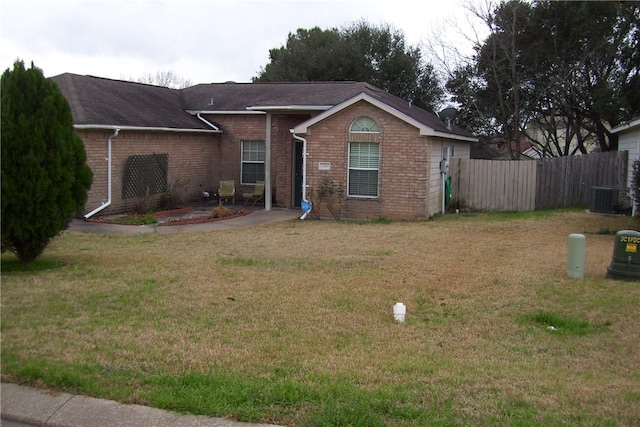 ranch-style house featuring central AC and a front yard