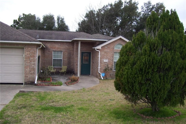 ranch-style home featuring a garage and a front lawn