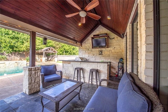 view of patio / terrace with ceiling fan and exterior bar