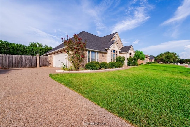 view of front of home with a garage and a front yard