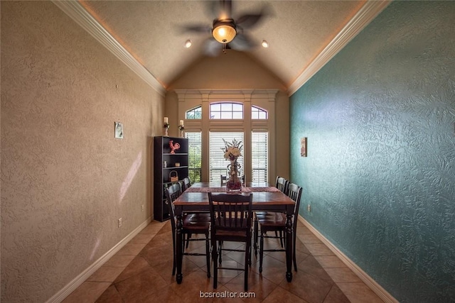 tiled dining room featuring ornamental molding, a textured ceiling, ceiling fan, and lofted ceiling