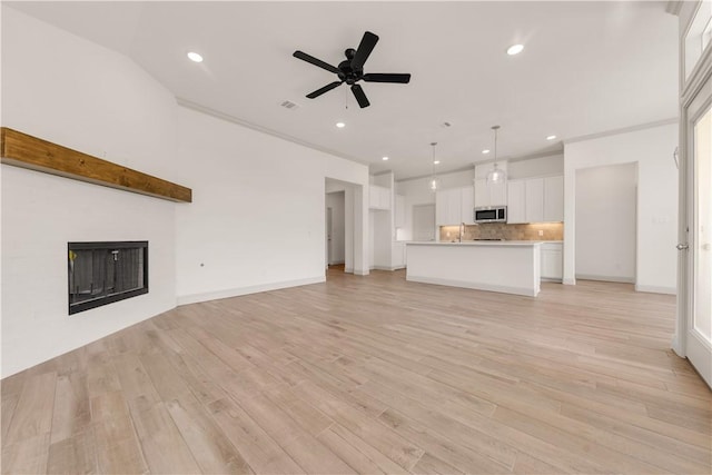 1615 Briscoe Manor Ct, College Station, TX 77845 - unfurnished living room with recessed lighting, visible vents, ceiling fan, and a sink