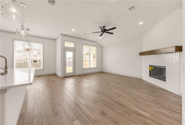 1615 Briscoe Manor Ct, College Station, TX 77845 - unfurnished living room with a fireplace, ceiling fan with notable chandelier, visible vents, and light wood-style floors