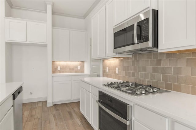 1615 Briscoe Manor Ct, College Station, TX 77845 - kitchen featuring white cabinets, light countertops, and appliances with stainless steel finishes