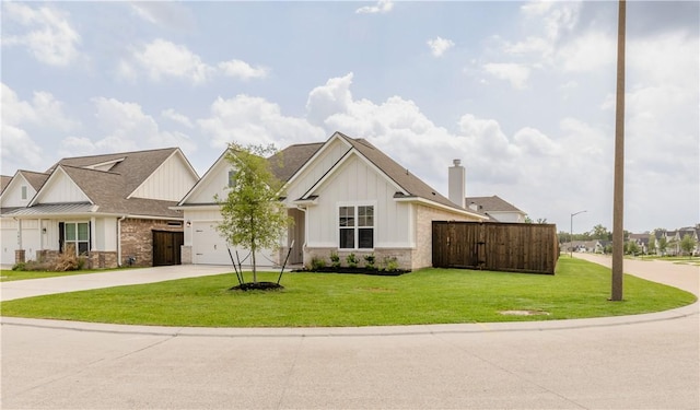 1615 Briscoe Manor Ct, College Station, TX 77845 - view of front facade with driveway, a front lawn, fence, and board and batten siding
