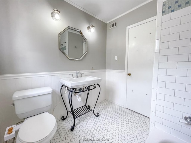 bathroom with toilet and crown molding