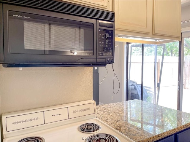 kitchen with stove and light stone countertops