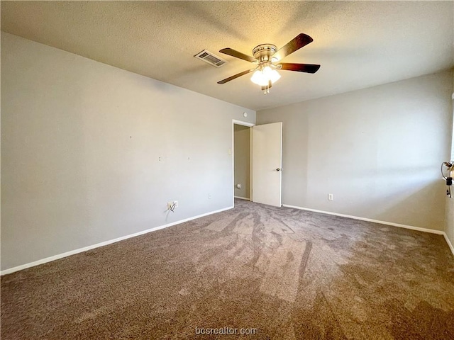 carpeted spare room featuring ceiling fan and a textured ceiling