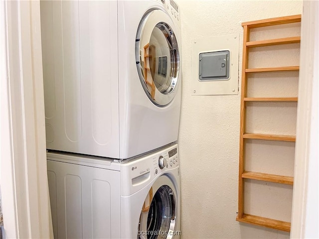 laundry room featuring stacked washer / drying machine