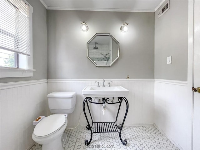 bathroom featuring crown molding, tile patterned flooring, and toilet