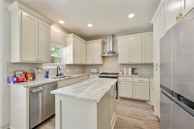 6209 Cromwell Ct, Bryan, TX 77802 - kitchen with wall chimney exhaust hood, stainless steel appliances, backsplash, light wood finished floors, and a kitchen island