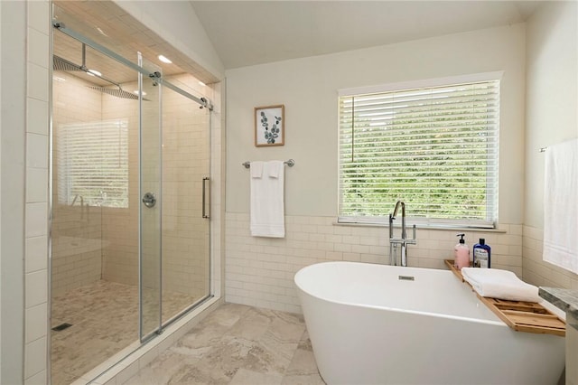6209 Cromwell Ct, Bryan, TX 77802 - bathroom featuring a shower stall, a freestanding tub, tile walls, and wainscoting