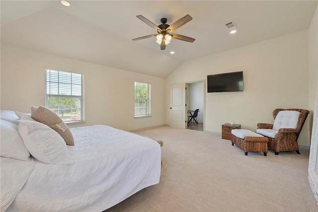 bedroom featuring light carpet, multiple windows, lofted ceiling, and ceiling fan