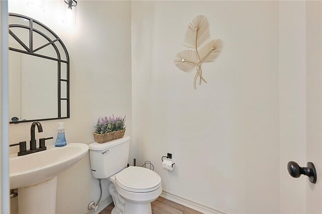 6209 Cromwell Ct, Bryan, TX 77802 - bathroom with toilet and wood finished floors