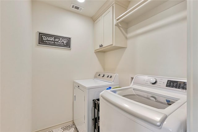 laundry area with cabinets and independent washer and dryer