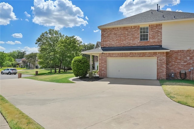 view of front of home with a front yard and a garage