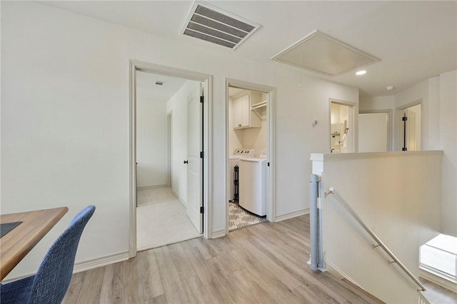 office space featuring light hardwood / wood-style flooring and washing machine and clothes dryer