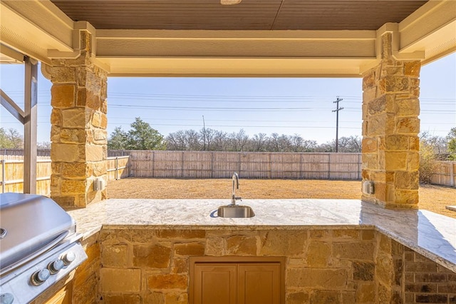 view of patio featuring a grill, sink, and area for grilling