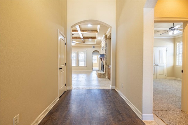 hall featuring wood-type flooring, plenty of natural light, coffered ceiling, and beam ceiling